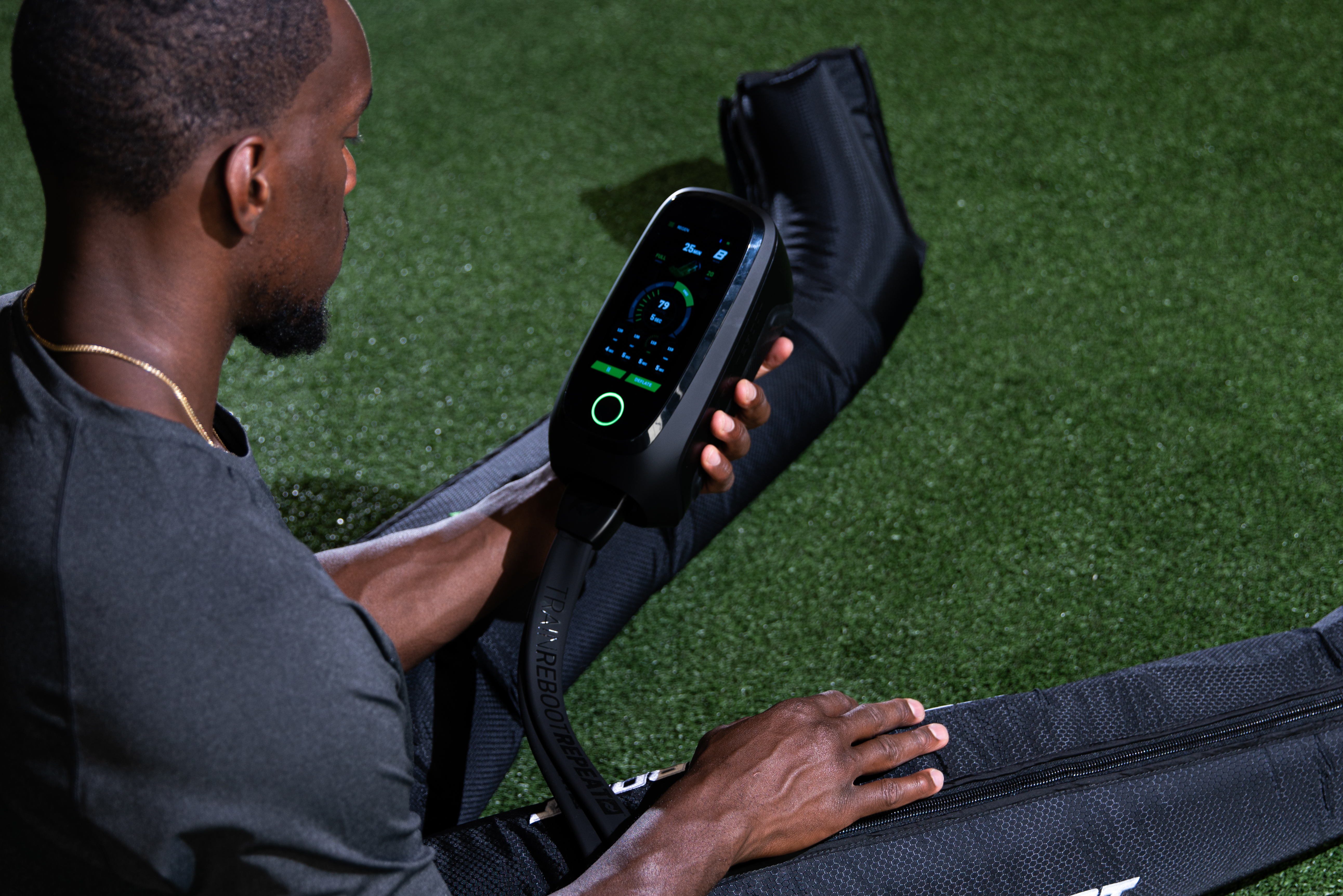 Athlete in Rapid Reboot REGEN compression boots after a field training session.