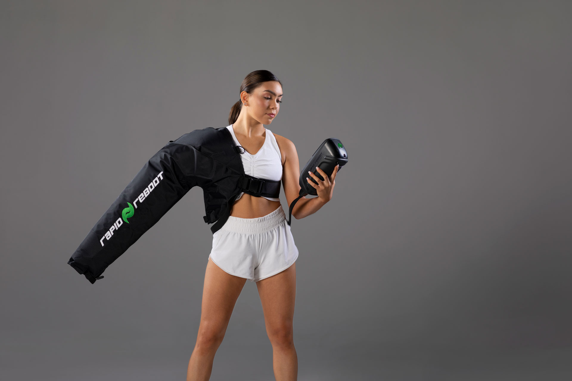 Athlete using Rapid Reboot REGEN arm attachment, highlighting the full modular recovery ecosystem.