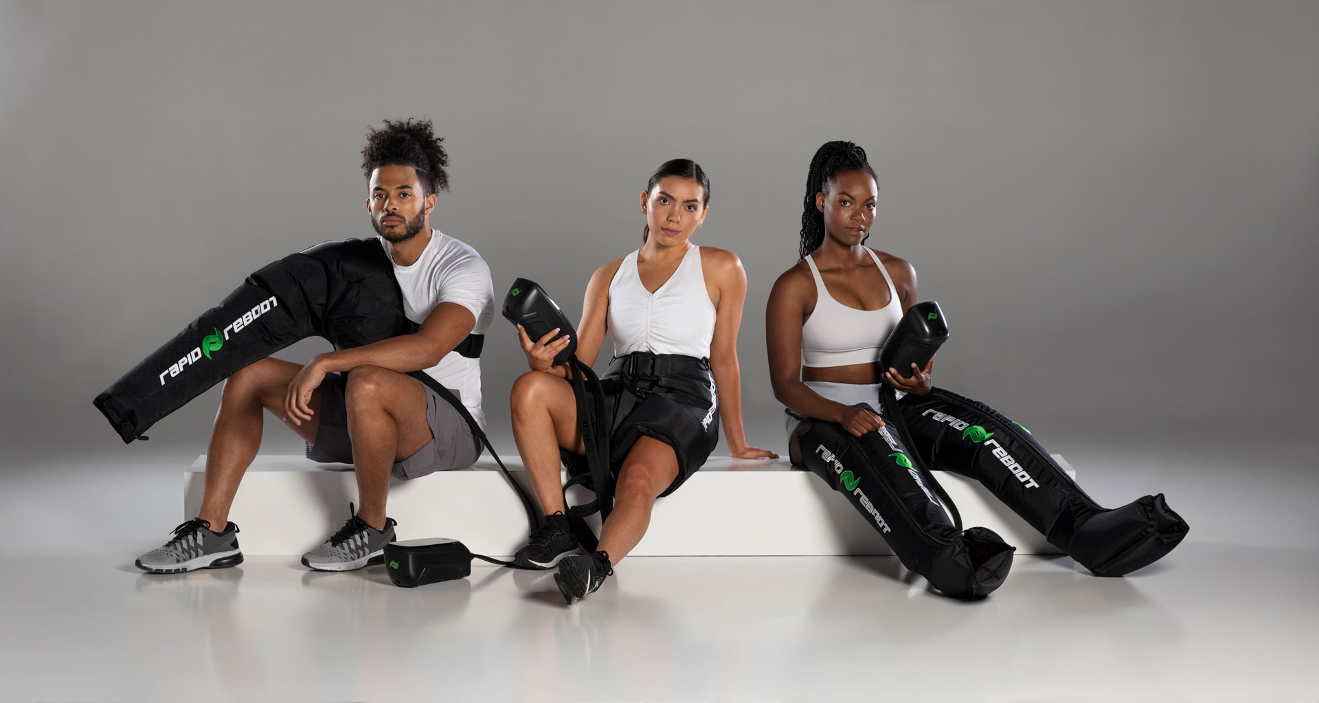 Team of athletes using Rapid Reboot REGEN compression boots in a professional training setting.